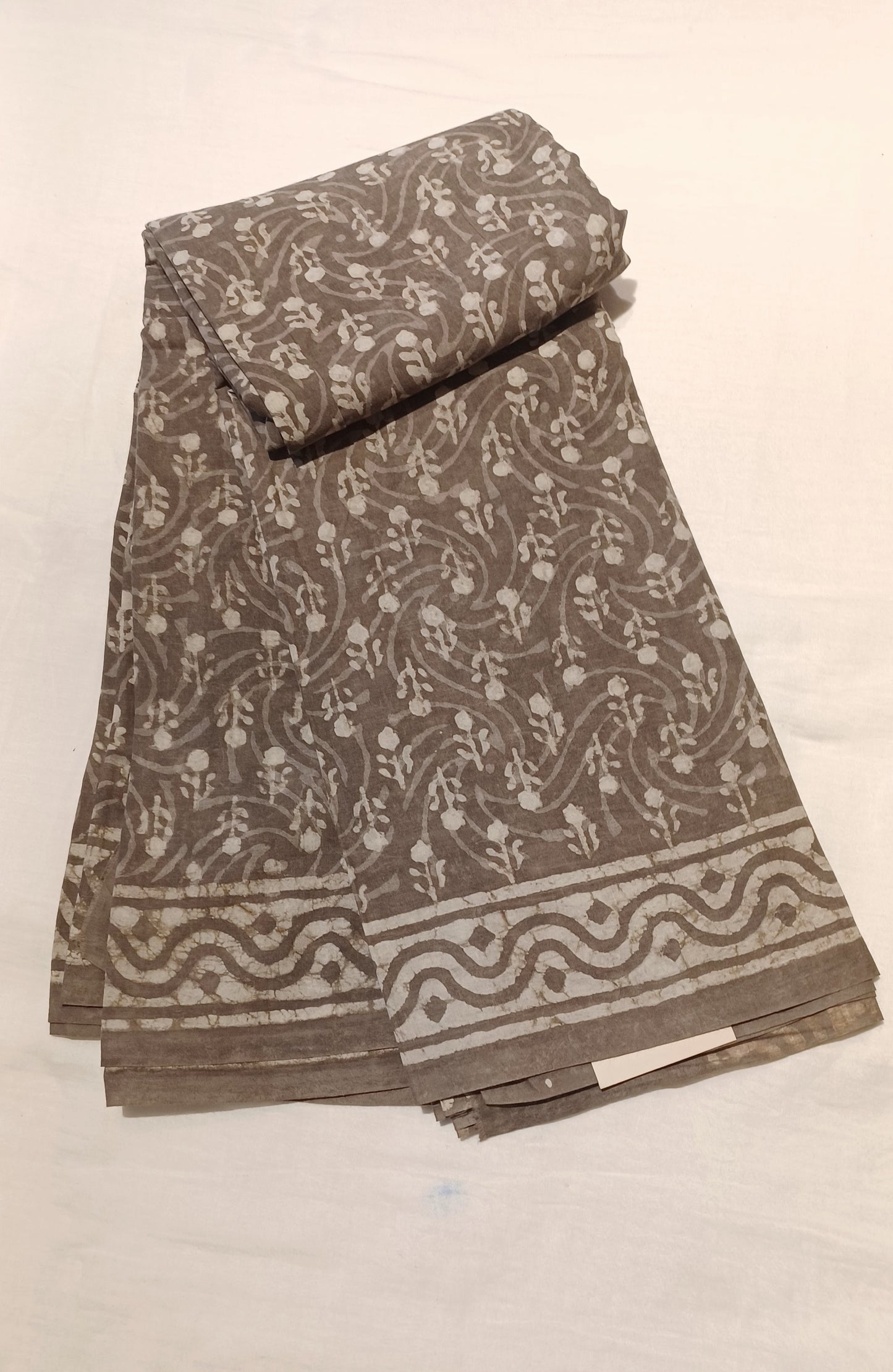 Brownish grey soft cotton dabu handblock print saree folded